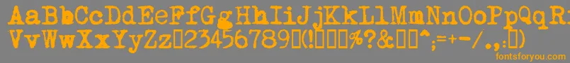 MomsTypewriter Font – Orange Fonts on Gray Background