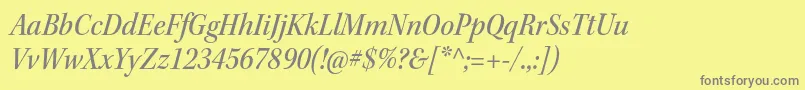 KeplerstdMediumscnitsubh-fontti – harmaat kirjasimet keltaisella taustalla