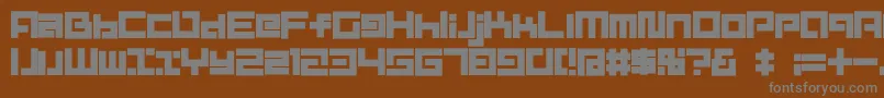 D3MouldismAlphabet-fontti – harmaat kirjasimet ruskealla taustalla
