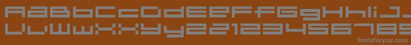 04b31-fontti – harmaat kirjasimet ruskealla taustalla
