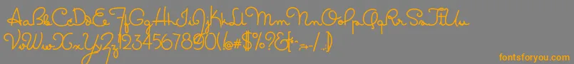 フォントMasanascript2grata – オレンジの文字は灰色の背景にあります。