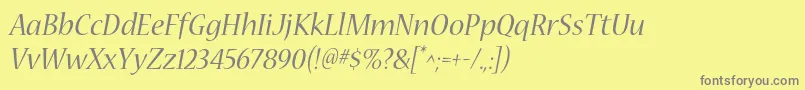 フォントNuevastdItalic – 黄色の背景に灰色の文字