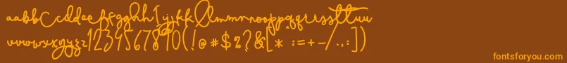 フォントCestlaisabelly – オレンジ色の文字が茶色の背景にあります。