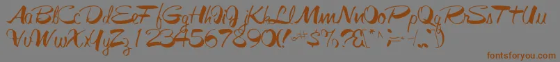 フォントGalacticfuss72Regular – 茶色の文字が灰色の背景にあります。
