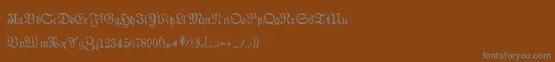 Auldmagick-fontti – harmaat kirjasimet ruskealla taustalla
