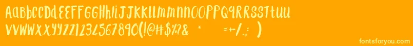 F...SaintTropez-Schriftart – Gelbe Schriften auf orangefarbenem Hintergrund