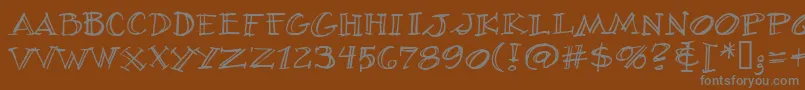 VillageIdiotBb-fontti – harmaat kirjasimet ruskealla taustalla