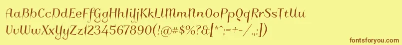 フォントCharakterny – 茶色の文字が黄色の背景にあります。