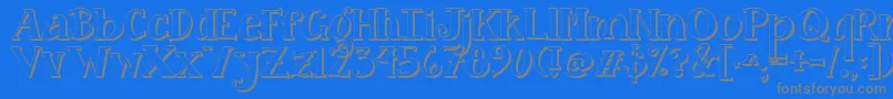 Jandacurlygirlpop-fontti – harmaat kirjasimet sinisellä taustalla