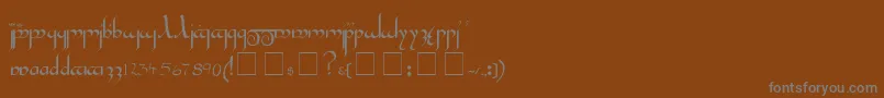 Tengwar-fontti – harmaat kirjasimet ruskealla taustalla