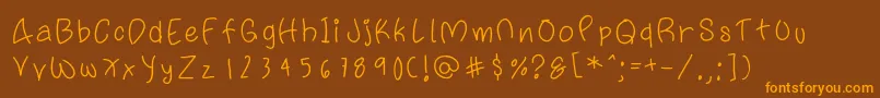 フォントFattypants – オレンジ色の文字が茶色の背景にあります。