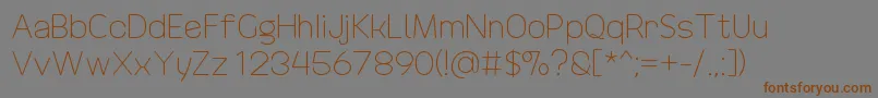 DrakoheartRevofitLight-Schriftart – Braune Schriften auf grauem Hintergrund