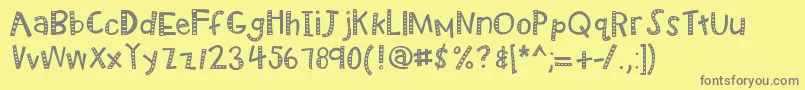 Kbradiowizard-fontti – harmaat kirjasimet keltaisella taustalla