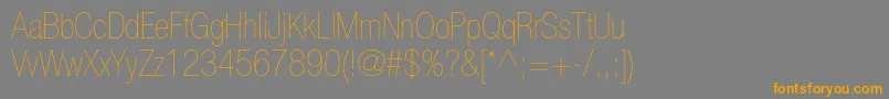 フォントHelveticaneueltstdUltltcn – オレンジの文字は灰色の背景にあります。
