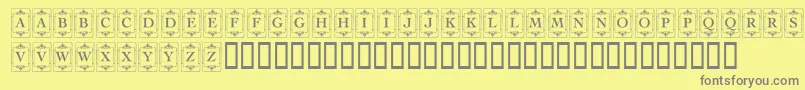 KrDecoCapsOne-fontti – harmaat kirjasimet keltaisella taustalla