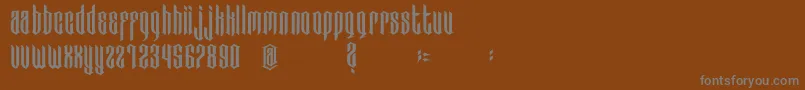 BadBoys-fontti – harmaat kirjasimet ruskealla taustalla