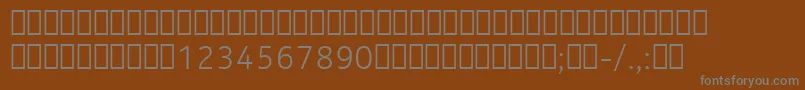 NokiaPureTextLightT-fontti – harmaat kirjasimet ruskealla taustalla