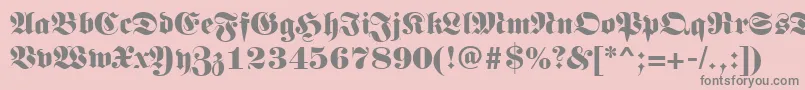 Germanregular-fontti – harmaat kirjasimet vaaleanpunaisella taustalla
