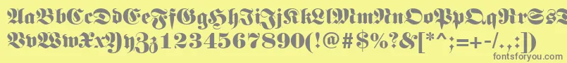Germanregular-fontti – harmaat kirjasimet keltaisella taustalla