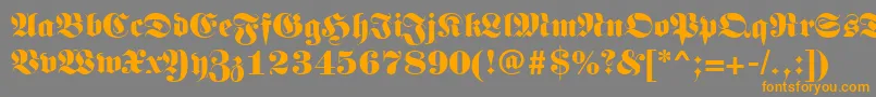 フォントGermanregular – オレンジの文字は灰色の背景にあります。