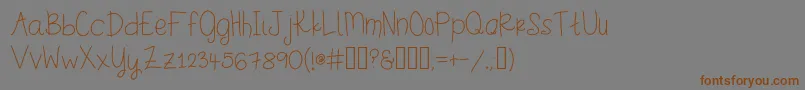 フォントStinkerpotomus – 茶色の文字が灰色の背景にあります。