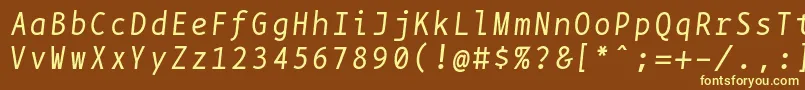 Bpmonoitalics-fontti – keltaiset fontit ruskealla taustalla