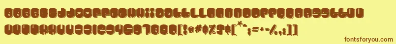 フォントCosmojun – 茶色の文字が黄色の背景にあります。