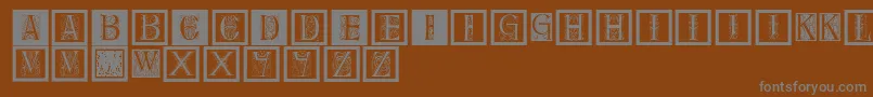 Delitzschcaps-Schriftart – Graue Schriften auf braunem Hintergrund