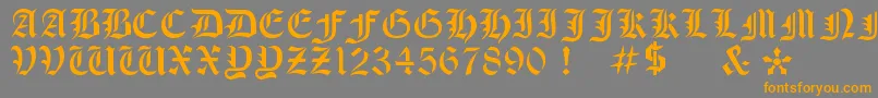 フォントOldeStencil – オレンジの文字は灰色の背景にあります。