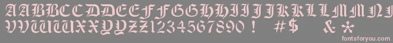 フォントOldeStencil – 灰色の背景にピンクのフォント