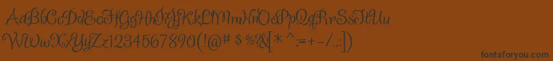 フォントSladkoeshka – 黒い文字が茶色の背景にあります