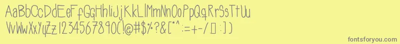 フォントSoozieqs – 黄色の背景に灰色の文字