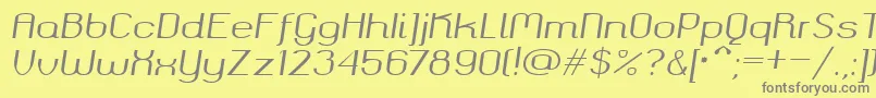 Okolaksregularitalic-fontti – harmaat kirjasimet keltaisella taustalla