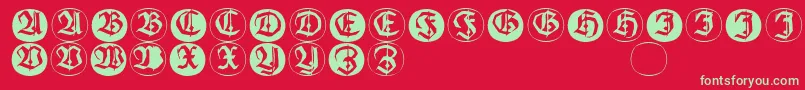 フォントFrakturinitialenangularround – 赤い背景に緑の文字
