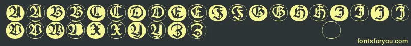 Frakturinitialenangularround-fontti – keltaiset fontit mustalla taustalla