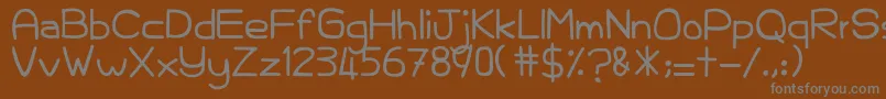 KelamKabut-fontti – harmaat kirjasimet ruskealla taustalla