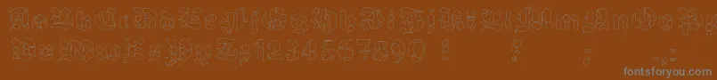 GrobehandFo-fontti – harmaat kirjasimet ruskealla taustalla