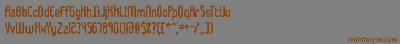 フォントDentedBrk – 茶色の文字が灰色の背景にあります。