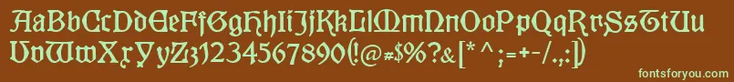Kuenstlergotisch-fontti – vihreät fontit ruskealla taustalla