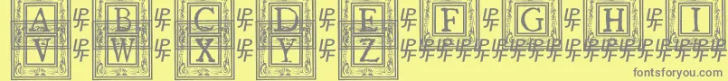 QuanauticaleInitialsNo1-fontti – harmaat kirjasimet keltaisella taustalla