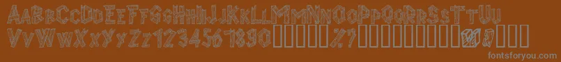 Alphawood-Schriftart – Graue Schriften auf braunem Hintergrund