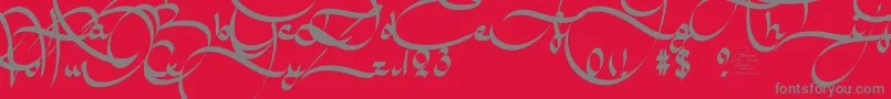 AmalScriptBold-fontti – harmaat kirjasimet punaisella taustalla