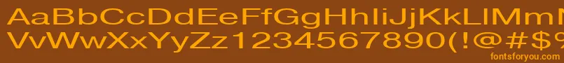 フォントPragmaticactt160n – オレンジ色の文字が茶色の背景にあります。