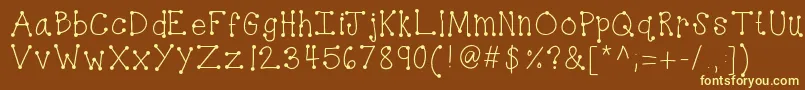 Kbdottydot-Schriftart – Gelbe Schriften auf braunem Hintergrund