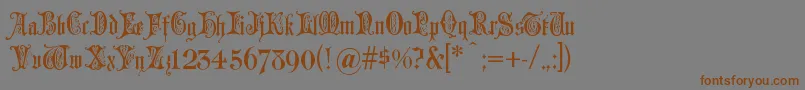 フォントGrusskartengotisch – 茶色の文字が灰色の背景にあります。