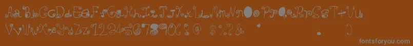 Crazycurlz Font – Gray Fonts on Brown Background