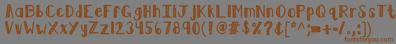 フォントKblimelight – 茶色の文字が灰色の背景にあります。