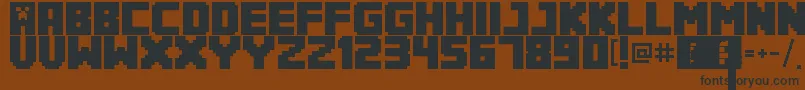 Minecrafter3Regular-Schriftart – Schwarze Schriften auf braunem Hintergrund