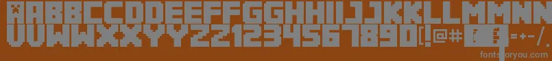 Minecrafter3Regular-Schriftart – Graue Schriften auf braunem Hintergrund