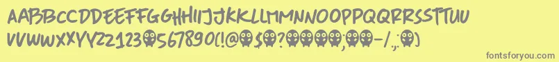 フォントDkMoreOrLess – 黄色の背景に灰色の文字